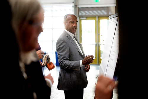 Chancellor Gary S. May brainstorms at a white board