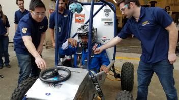 Chancellor May visits the College of Engineering Aggie Baja lab and takes their student designed racecar for a ride. 
