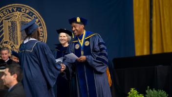 Chancellor May congratulates a graduating UC Davis student at commencement. 
