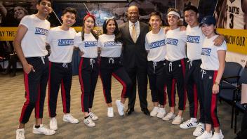UC Davis Chancellor Gary May poses for a photo with the MK Modern dance group before the start or their performance at the Fall Welcome Event.