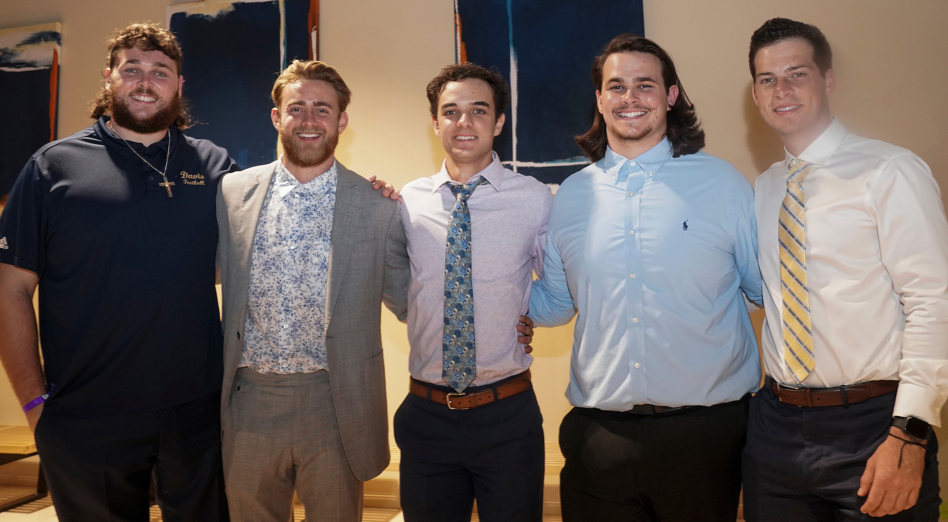 Five Aggie football players pose at the Shining Stars prom