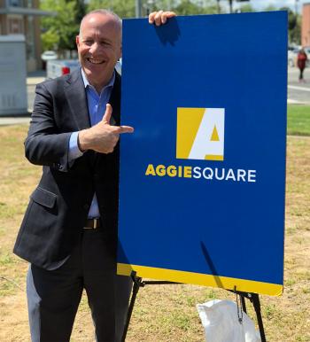 Mayor Steinberg by Aggie Square sign