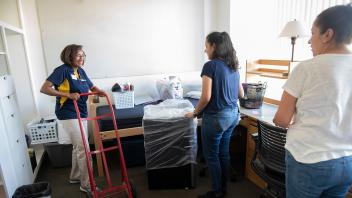 Helene Dillard, Dean of the College of Agriculture and Environmental Sciences helps new students move-in to the Segundo residence halls. 