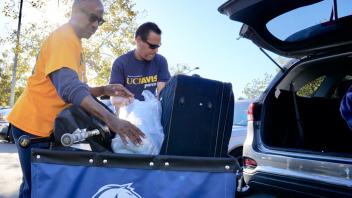 UC Davis Chancellor, Gary May helps students move-in to the Tercero Residence halls on Sunday, September 23, 2018