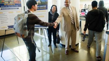 Chancellor Gary May talks with a group of students inside the Activities and Recreation Center (ARC).