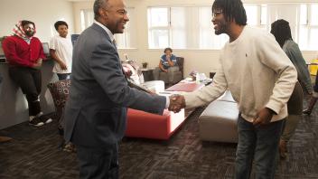 Chancellor Gary May shakes hands with a student as he visits at the Center of African Diaspora Student Success