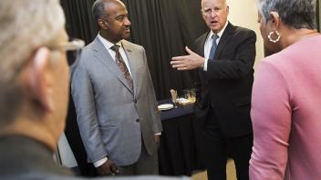 Chancellor Gary May and Governor Jerry Brown chat with two unidentified people before joining the symposium honoring the California Air Resources Board 50th Anniversary Symposium at the UC Davis Conference Center.