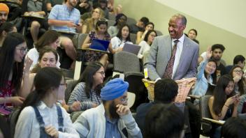 Chancellor Gary May passes out cookies to a group of students as he interrupts the class to give professor Judy Callis the UC Davis Teaching Prize.