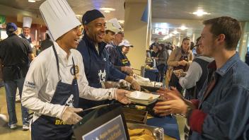 Chancellor Gary May and LeShelle May serve a late-night breakfast to students inside the ASUCD Coffee House