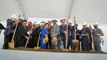 Group photo of Chancellor Gary May with other leaders digging into dirt with golden shovels