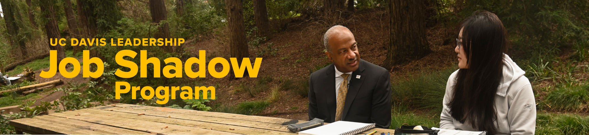 Chancellor Gary S. May and a student talking in the Arboretum