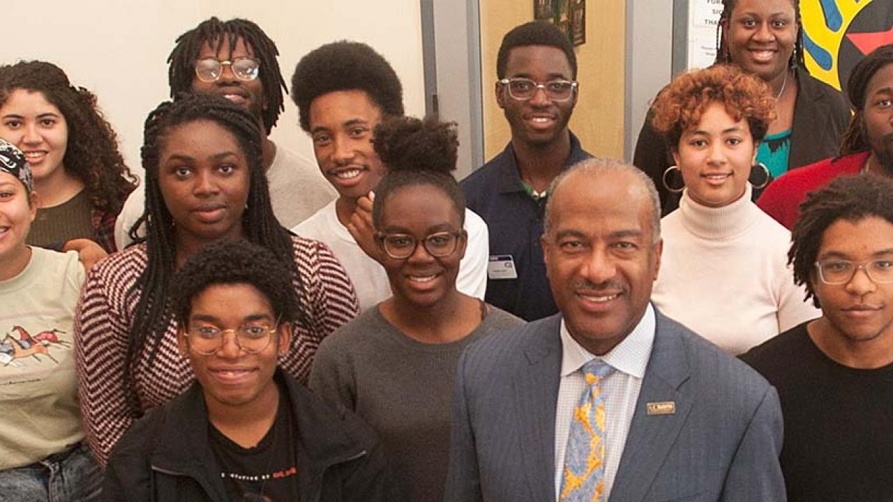 UC Davis Chancellor Gary May stand with students at the Center of African Diaspora Student Success on December 1, 2017