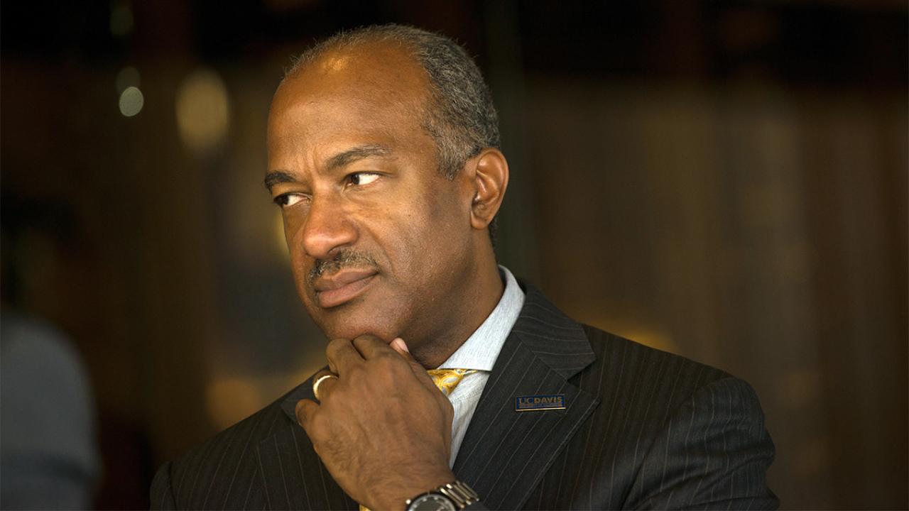 Chancellor Gary S. May looking to the left.