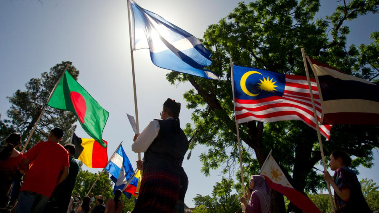 Picnic Day Parade participants carry flags from around the world. Parade participants carry flags of various nations.