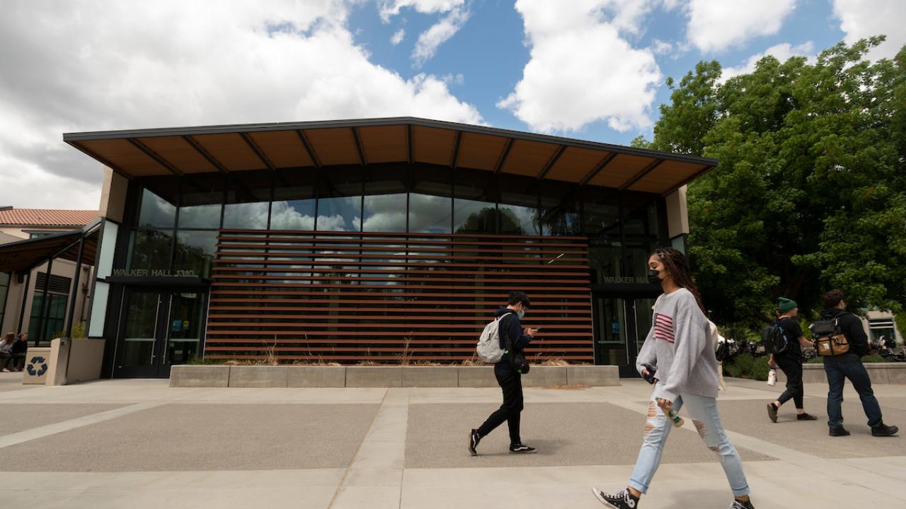 Students walk in front of Walker Hall.