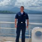 Joseph Laughlin poses on a Navy ship.