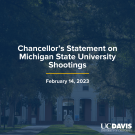 A composite image of Mrak Hall lawn with Egghead dark blue overlay that reads, "Statement on Michigan State University Shootings", with a navy blue line underneath and the date of February 14, 2023 below with a white UC Davis word mark in the bottom right corner.