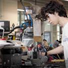 Student working on machine in engineering center