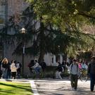 Students walk and ride bicycles outside Shields Library.